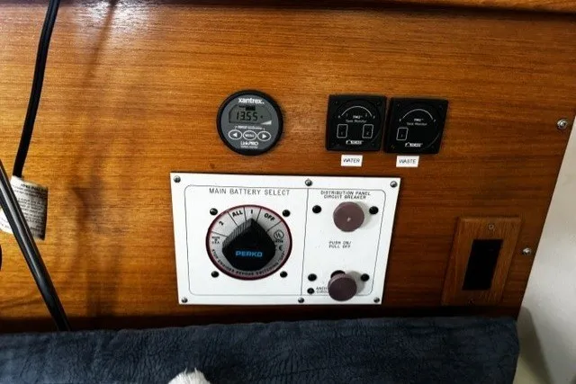 Control panel of a 2000 Catalina 320 sailboat with battery selector and gauges.