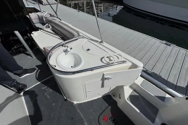1997 Sea Ray 240 Sundeck boat interior with sink and seating area.