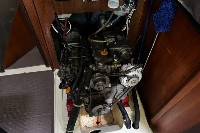Engine compartment of a 1996 Hunter 376 sailboat, showcasing mechanical components and wiring.