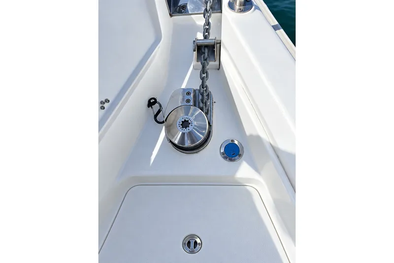 Anchor windlass on 1996 Hunter 376 sailboat deck, featuring chain and control panel.