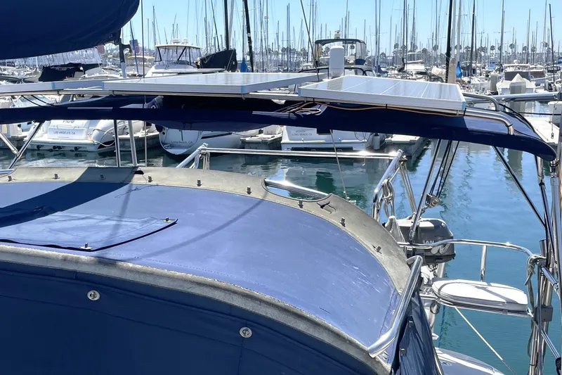 Catalina 350 sailboat, 2004 model, docked in marina with solar panels on deck.