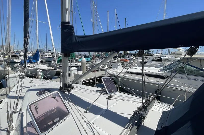 2004 Catalina 350 sailboat docked in a marina, surrounded by other boats.