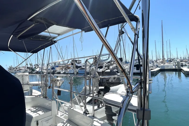 Sailboat Catalina 350, 2004 model, docked at marina with clear blue sky.