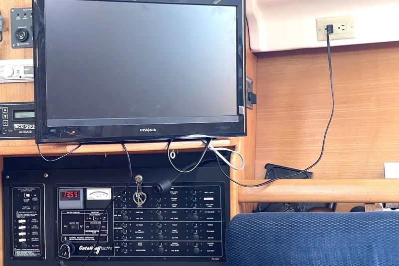 Control panel and TV setup inside a 2004 Catalina 350 yacht cabin.