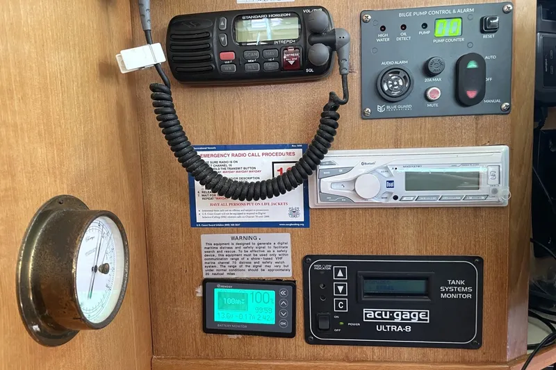 Control panel of a 2004 Catalina 350 yacht with radio, gauges, and alarm systems.