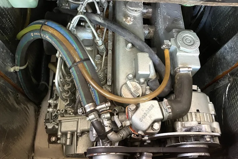 Catalina 350 2004 engine compartment with visible hoses and mechanical components.