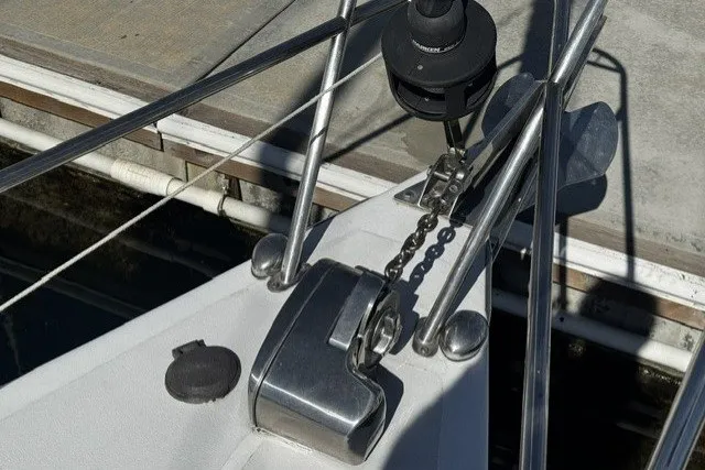 Bow of a 1973 Custom BILL LEE 40 sailboat with anchor chain and winch.