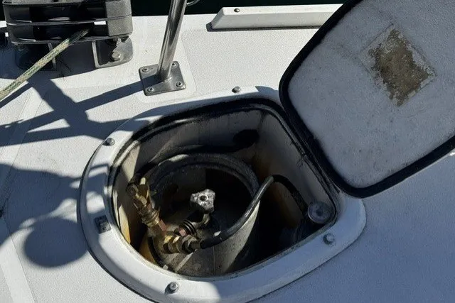 Open hatch on 1973 Custom BILL LEE 40 sailboat deck, revealing internal components.