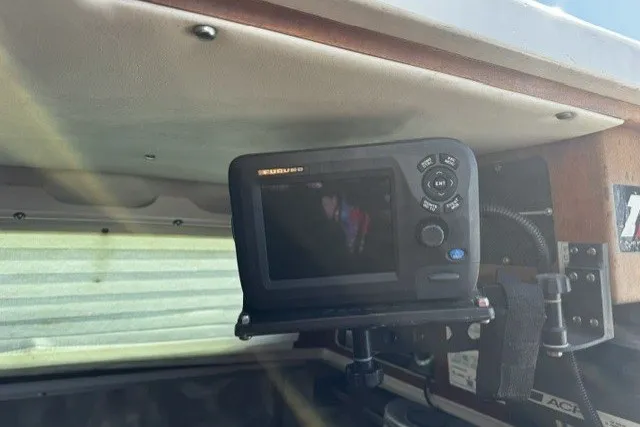 Fishfinder device mounted inside a 1973 Custom BILL LEE 40 boat cabin.