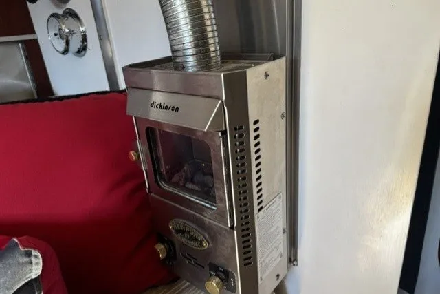 Compact marine heater inside a 1973 Custom BILL LEE 40 sailboat, featuring a Dickinson model.