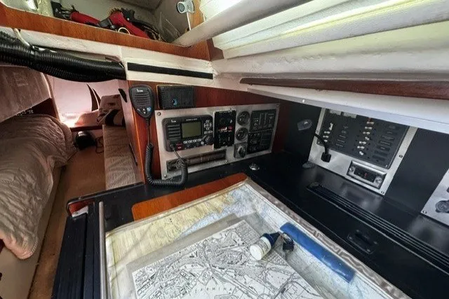 Interior of a 1973 Custom BILL LEE 40 sailboat with navigation equipment and map.