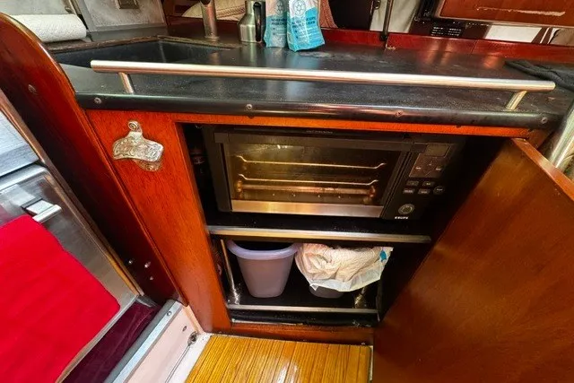 Kitchen area of a 1973 Custom BILL LEE 40 yacht with a built-in oven.