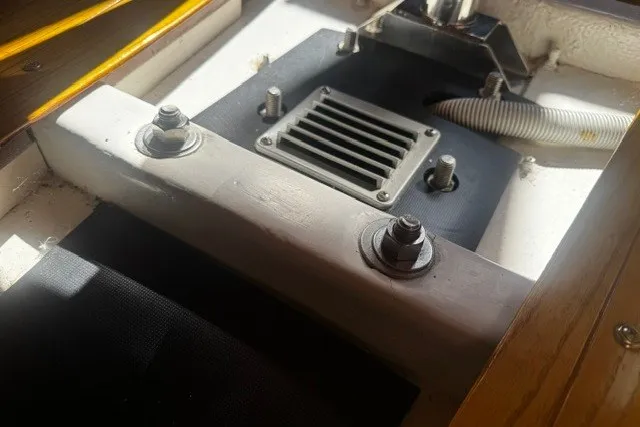 Engine compartment of a 1973 Custom BILL LEE 40 sailboat, featuring bolts and ventilation.