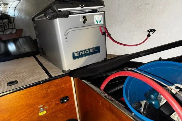 Interior of a 1973 Custom BILL LEE 40 yacht with Engel cooler and storage items.
