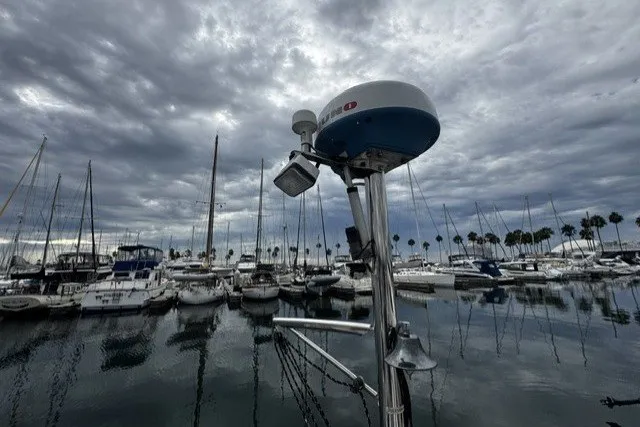 Marina with sailboats under cloudy sky, featuring a 1973 Custom BILL LEE 40.