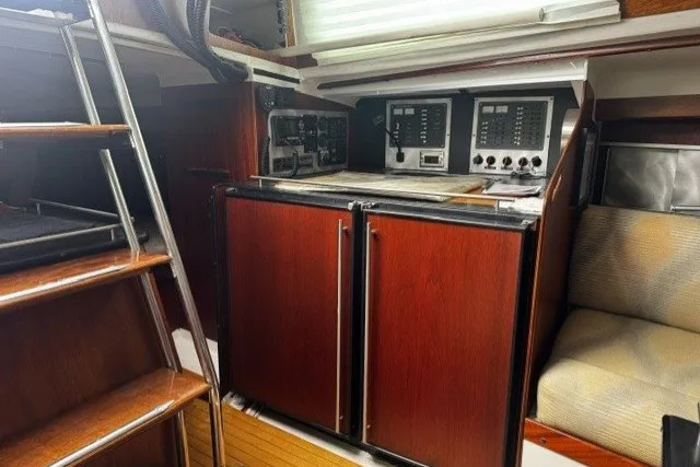 Interior of a 1973 Custom BILL LEE 40 yacht with wooden cabinetry and navigation equipment.