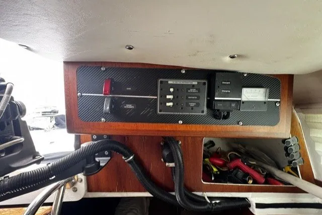 Control panel of a 1973 Custom BILL LEE 40 sailboat with wiring and switches.