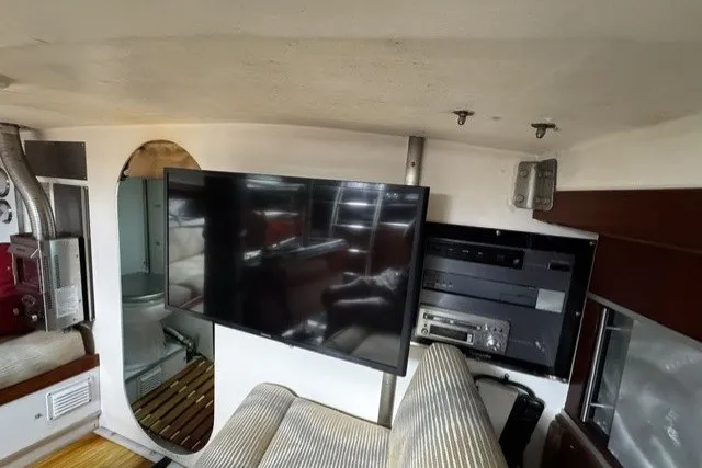 Interior of a 1973 Custom BILL LEE 40 yacht with modern TV and audio equipment.