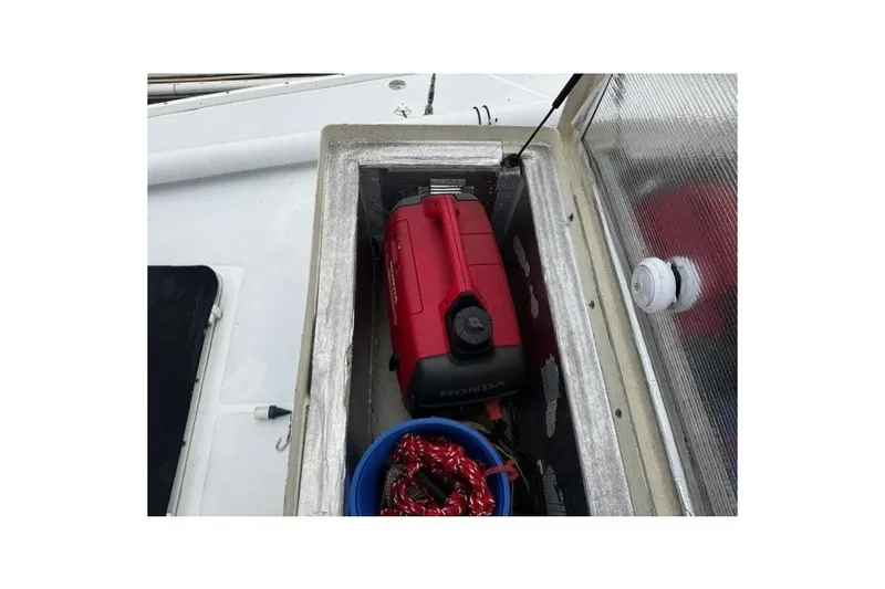 Storage compartment on 1973 Custom BILL LEE 40 sailboat with red Honda generator.