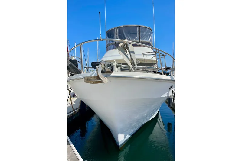 1985 CHB 42 yacht docked in marina, front view under clear blue sky.