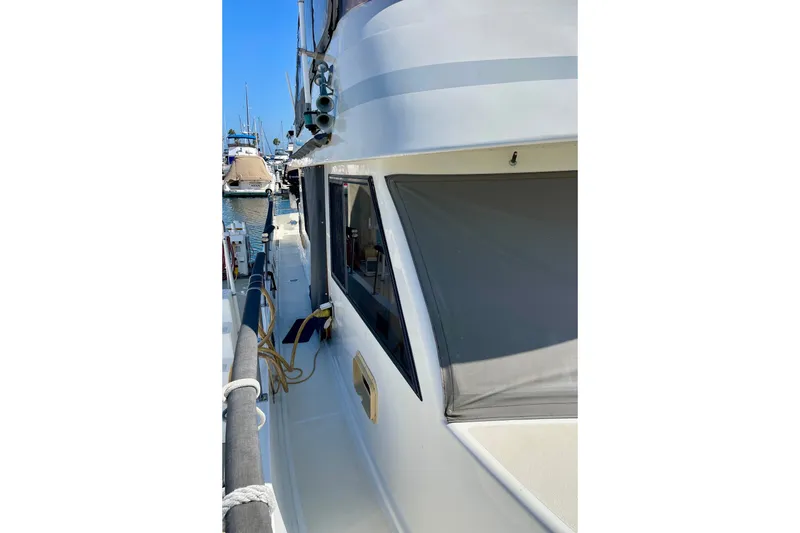 1985 CHB 42 boat docked at marina, side view with clear blue sky.