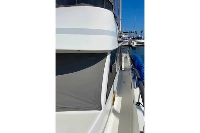 1985 CHB 42 yacht docked at marina, side view with clear blue sky.