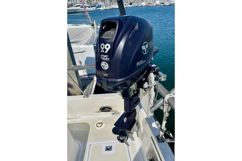 Outboard motor on a CHB 42 boat, 1985 model, docked at a marina.
