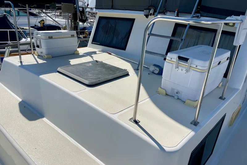 1985 CHB 42 boat deck with coolers and railing in a marina setting.
