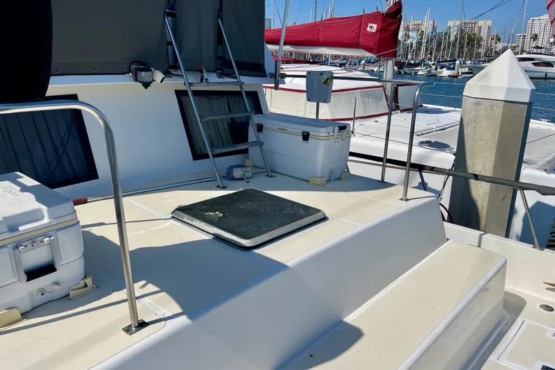 1985 CHB 42 yacht deck with coolers, ladder, and marina view.