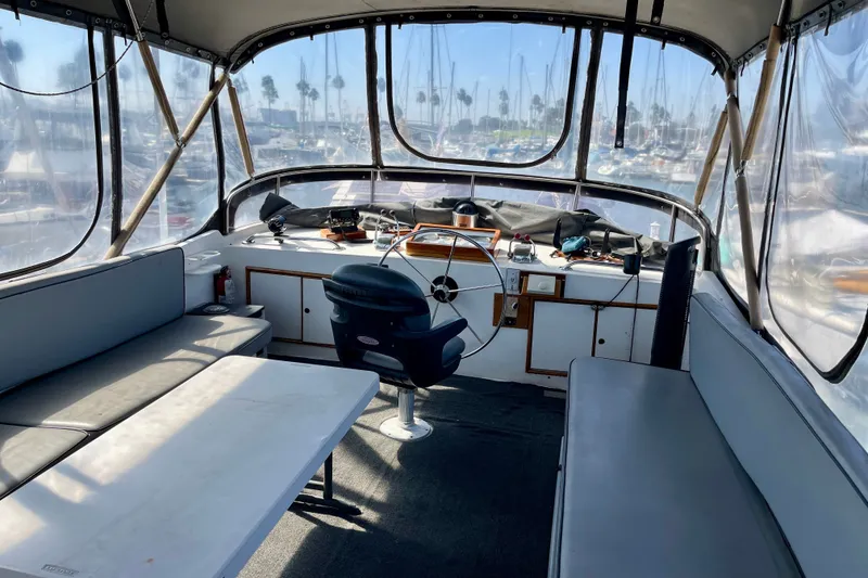 Interior view of a 1985 CHB 42 boat with seating and steering wheel.