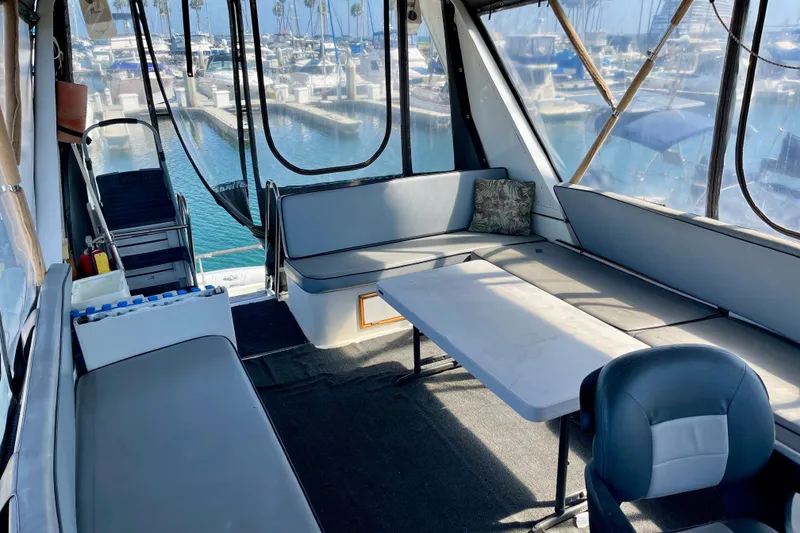 Interior of 1985 CHB 42 boat with seating, table, and marina view.