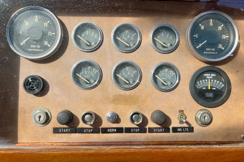 Dashboard of a 1985 CHB 42 boat with gauges and control switches.