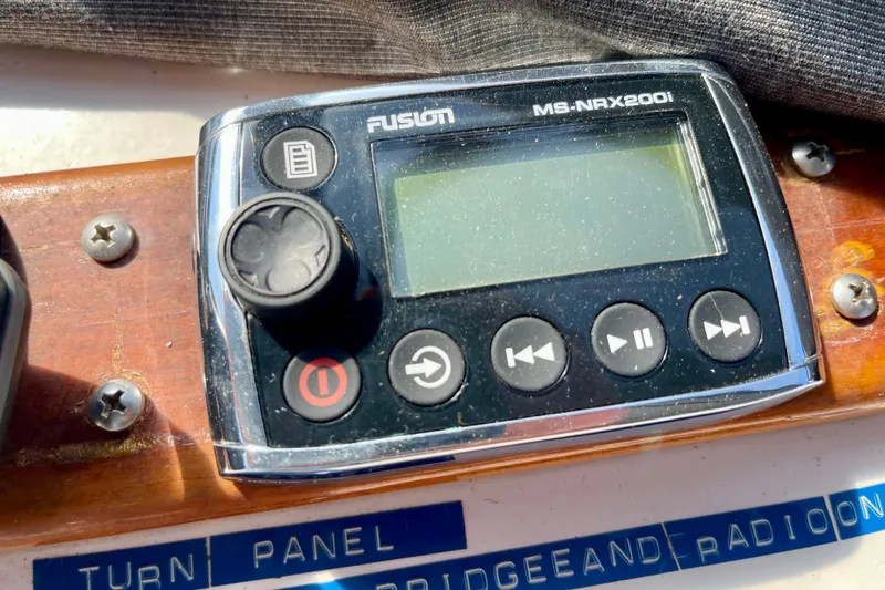 Fusion MS-NRX200i marine stereo controller on CHB 42, 1985 model boat dashboard.