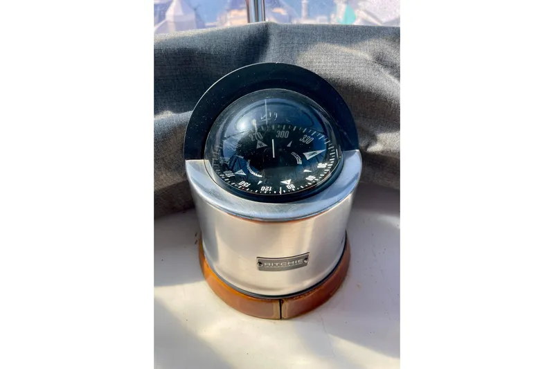 Ritchie compass on CHB 42 boat, 1985 model, with sunlight reflection.