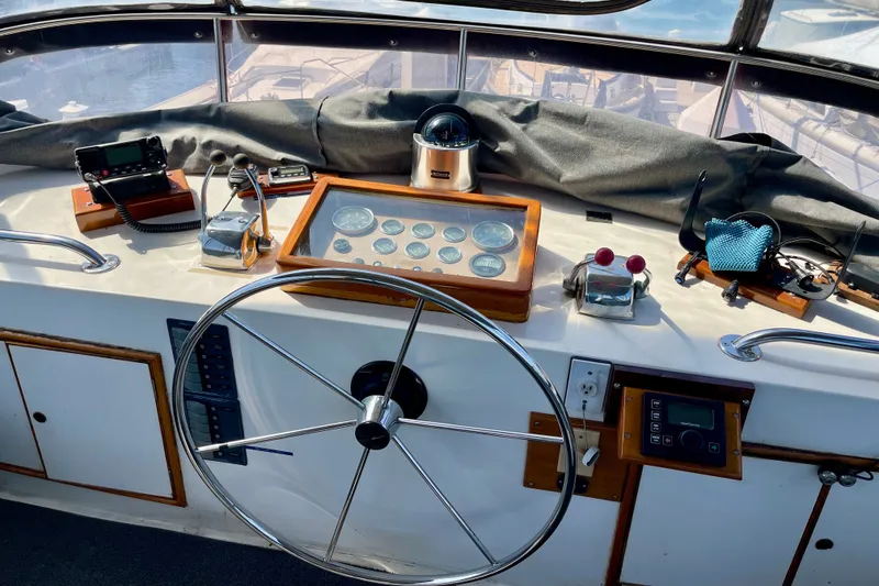 Helm of a 1985 CHB 42 boat with navigation instruments and steering wheel.