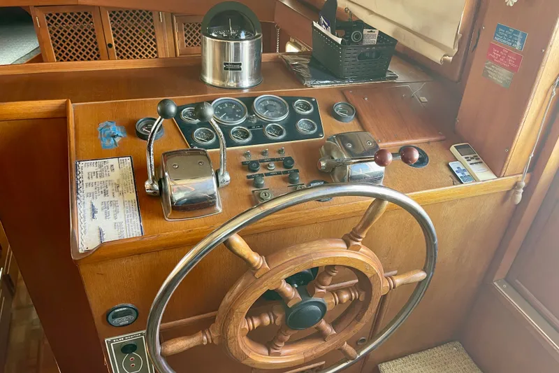 Wooden helm of a 1985 CHB 42 boat with gauges and controls.