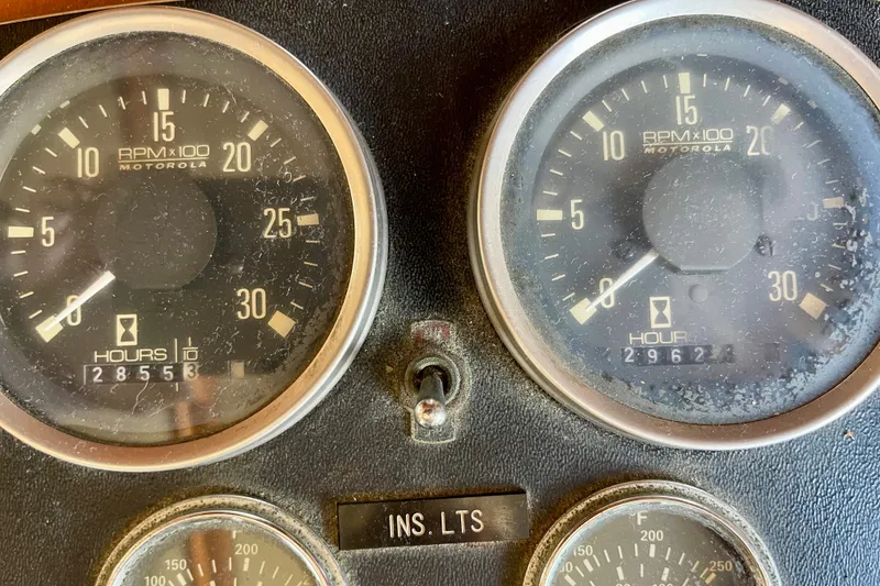 Close-up of CHB 42 boat's 1985 dashboard gauges showing RPM and engine hours.