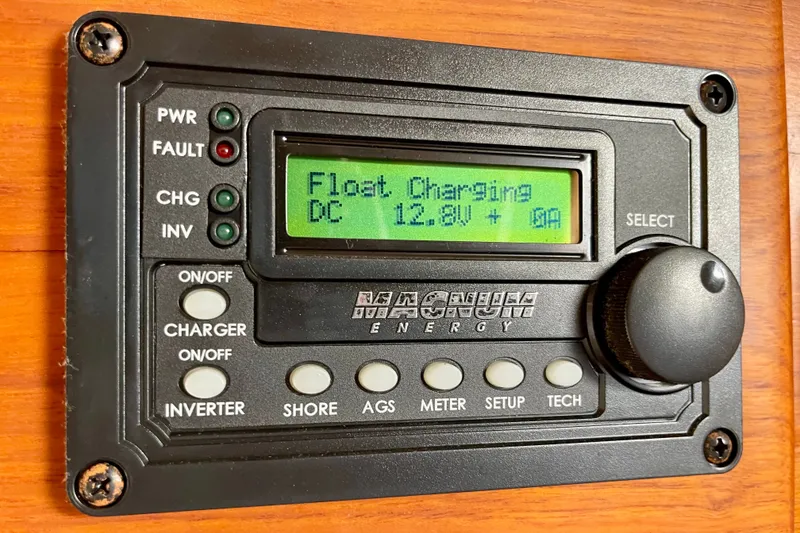 Magnum Energy control panel displaying float charging at 12.8V, installed on a 1985 CHB 42.