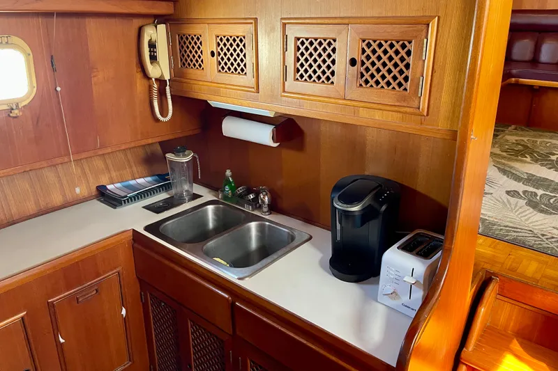 Galley kitchen in 1985 CHB 42 boat with sink, coffee maker, and toaster.