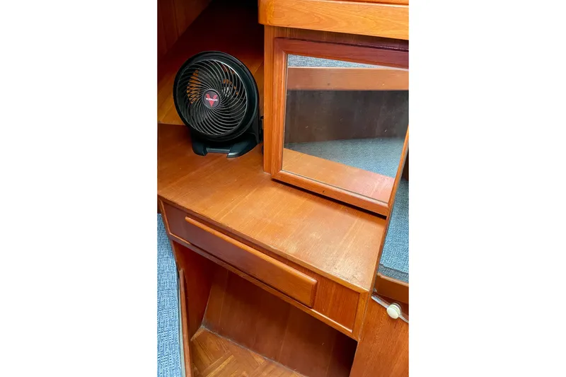 Wooden interior of 1985 CHB 42 boat with fan and mirror.