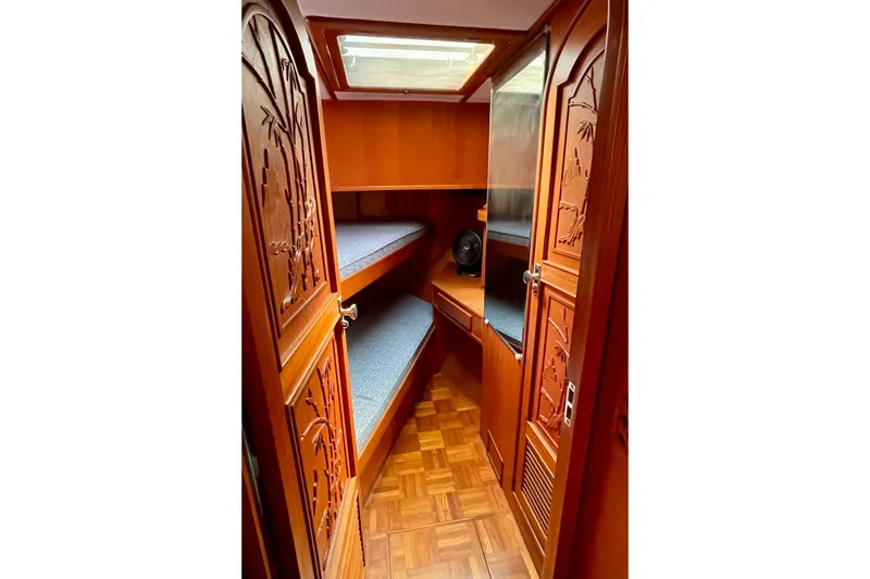Interior of 1985 CHB 42 boat with wooden cabinetry and bunk beds.
