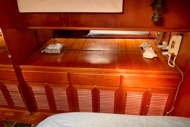 Wooden interior of 1985 CHB 42 boat with cabinets and vintage phone.