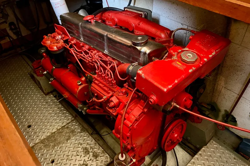 Red engine of a 1985 CHB 42 boat, showcasing intricate mechanical components.