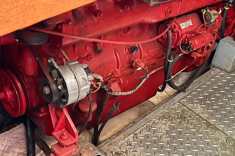 Red engine of a 1985 CHB 42 boat, featuring visible components and wiring.