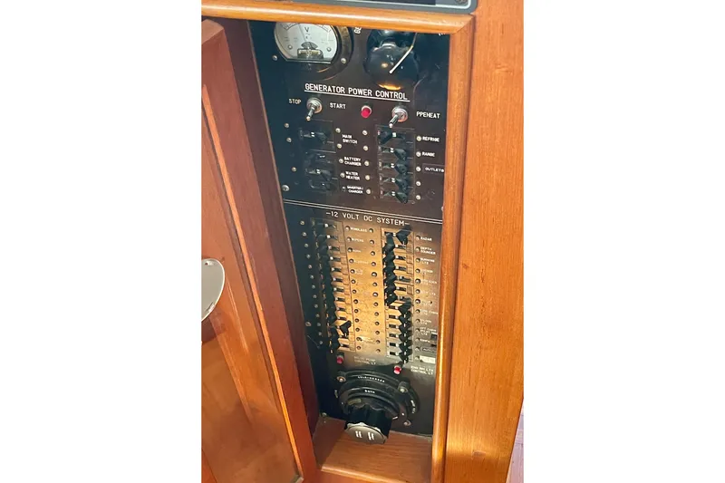 Electrical control panel on a 1985 CHB 42 boat, featuring generator and 12-volt DC system.
