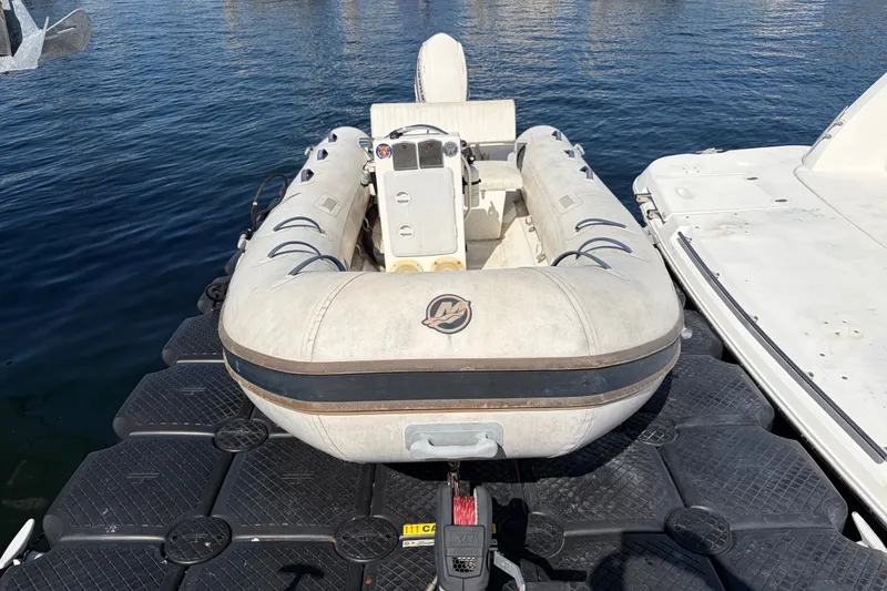 Inflatable dinghy docked beside a 1999 Cruisers Yachts 3870 Esprit.
