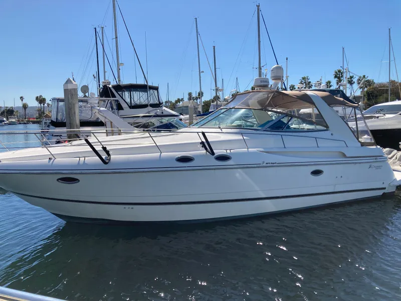 1999 Cruisers Yachts 3870 Esprit docked in a marina under clear blue skies.