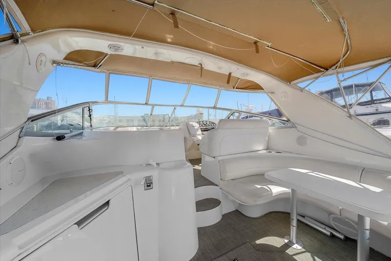 1999 Cruisers Yachts 3870 Esprit interior with white seating and canopy.