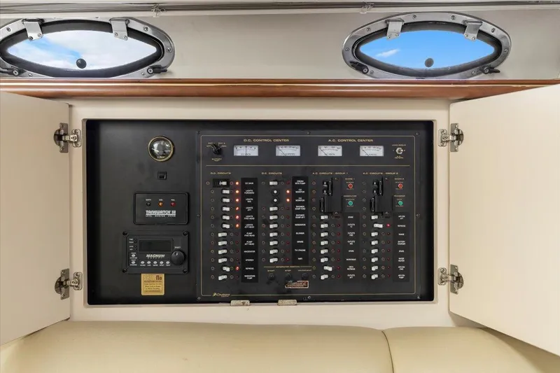 Electrical control panel inside 1999 Cruisers Yachts 3870 Esprit, featuring switches and gauges.