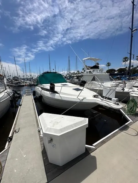 1996 Wellcraft 3200 Martinique docked at marina.
